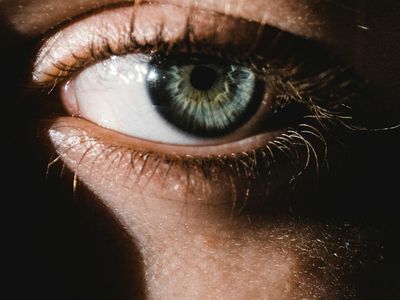 Calm person closing eyes in a dark room