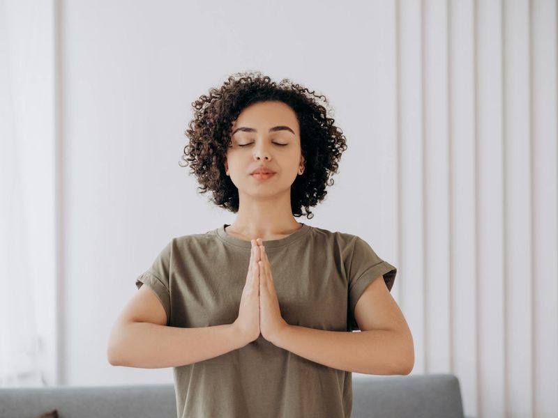 Person practicing eye exercises in a modern office with blue lighting